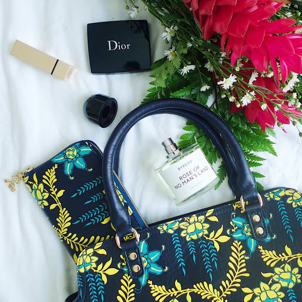 This leather, midnight blue, wallet is made with soft and light weight leather. The leather has a printed yellow leaf motif screen printed on the front.